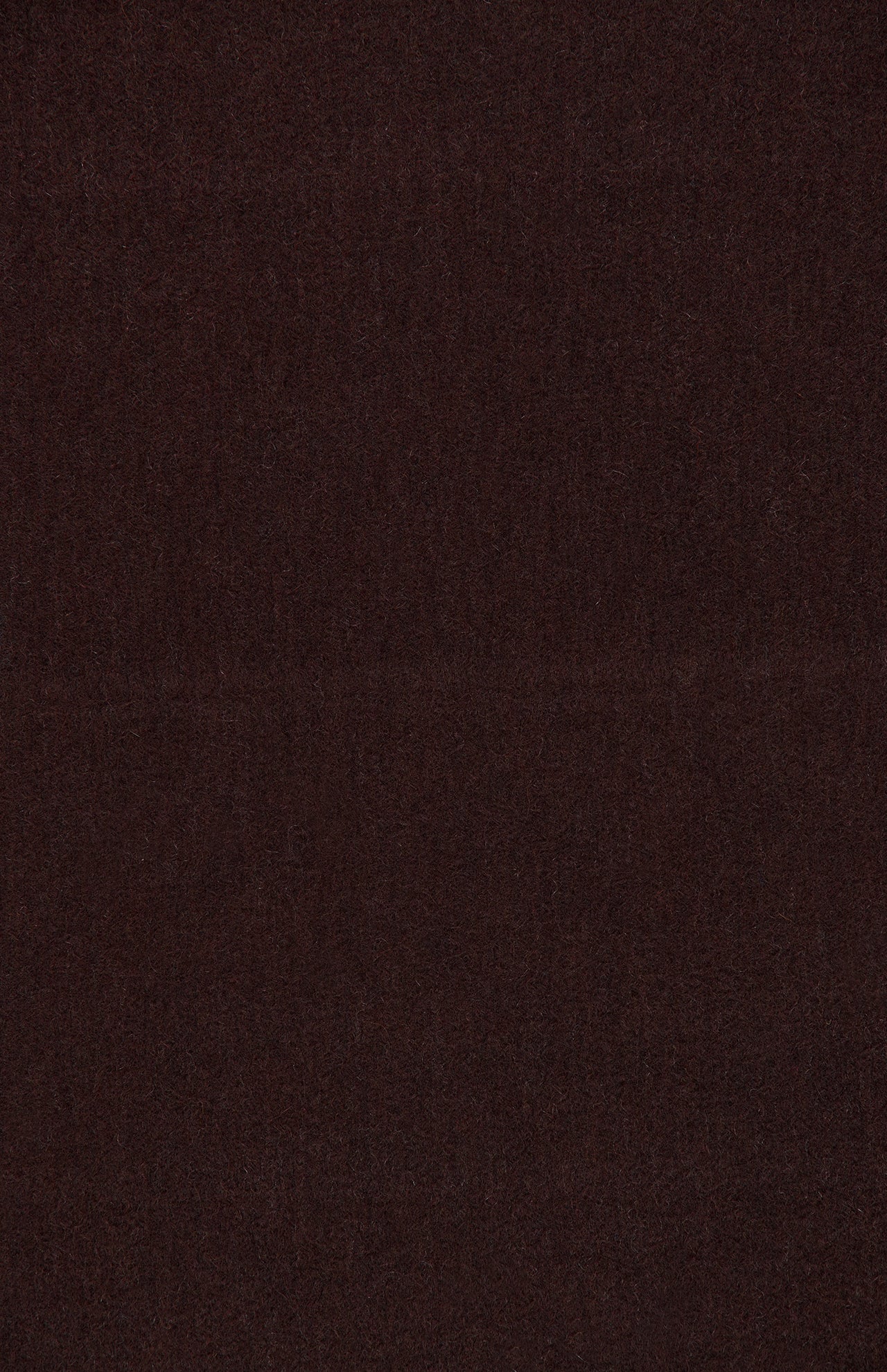 A rich, dark brown textured surface fills the entire image, evoking the luxurious feel of BEGG & CO’s Arran Reversible Scarf. The surface is seamless and without patterns or visible objects, reminiscent of premium cashmere fabric.