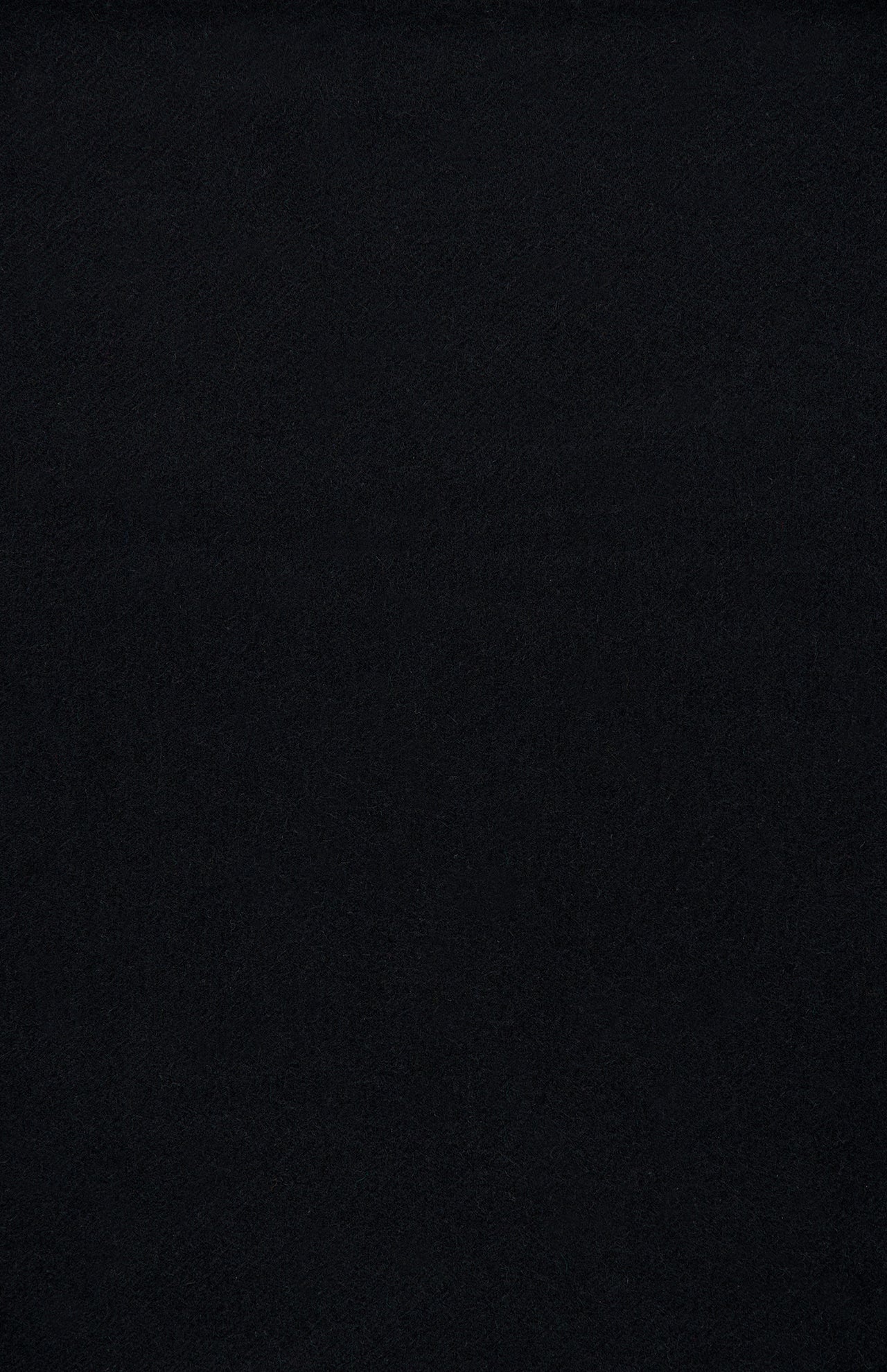 A solid, uniform black Arran Solid Scarf by BEGG & CO, featuring a luxurious cashmere-like finish with no visible patterns, textures, or objects.