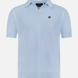 The BELSTAFF Coast Knitted Waffle Polo Shirt in light blue cotton-silk piqué features short sleeves, a Johnny collar, and a small embroidered logo patch on the left chest, shown on a plain white background.
