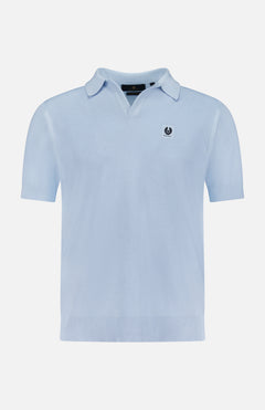 The BELSTAFF Coast Knitted Waffle Polo Shirt in light blue cotton-silk piqué features short sleeves, a Johnny collar, and a small embroidered logo patch on the left chest, shown on a plain white background.