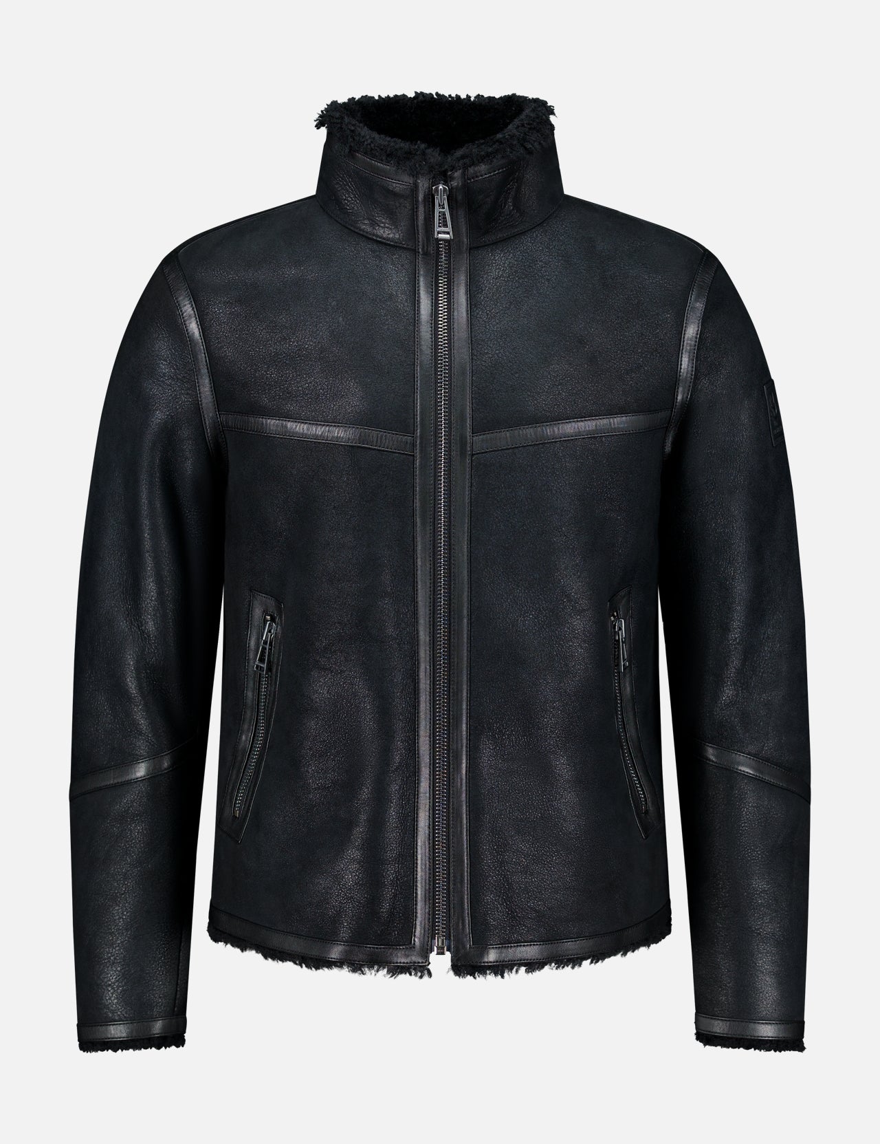 Channeling classic British heritage, the BELSTAFF Highland Shearling Jacket features a high collar and zipper closure, complemented by two zippered side pockets and a soft, textured finish. With its slightly rugged, matte appearance, visible stitching, and fleece-lined interior reminiscent of an English shearling jacket, it’s the perfect blend of timeless style and modern comfort.