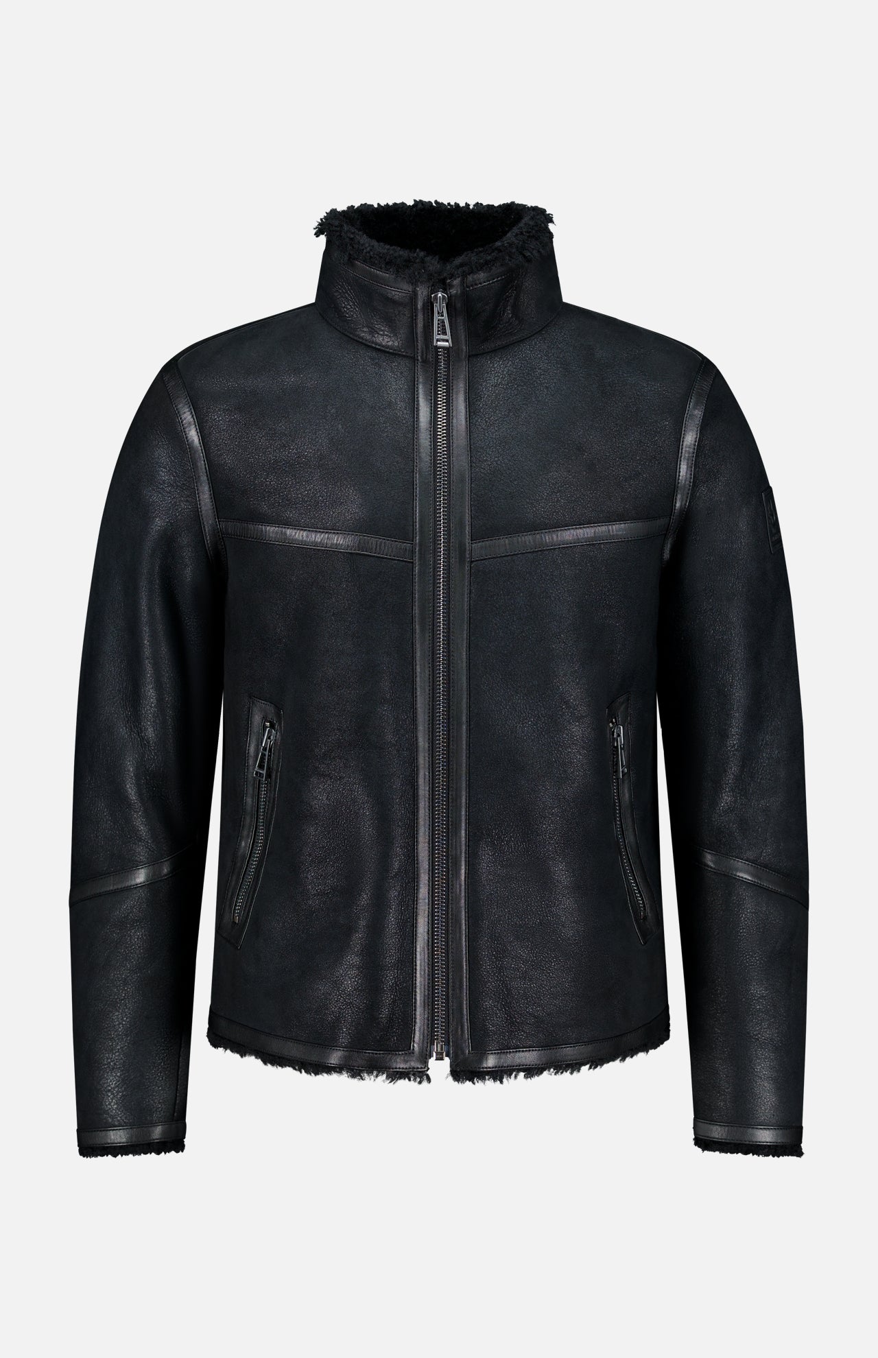 Channeling classic British heritage, the BELSTAFF Highland Shearling Jacket features a high collar and zipper closure, complemented by two zippered side pockets and a soft, textured finish. With its slightly rugged, matte appearance, visible stitching, and fleece-lined interior reminiscent of an English shearling jacket, it’s the perfect blend of timeless style and modern comfort.