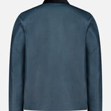Back view of the BELSTAFF Incline Field Jacket in blue waxed cotton with long sleeves and a black collar, displayed against a plain white background. This water- and wind-repellent jacket pairs classic BELSTAFF style with practical protection from the elements.
