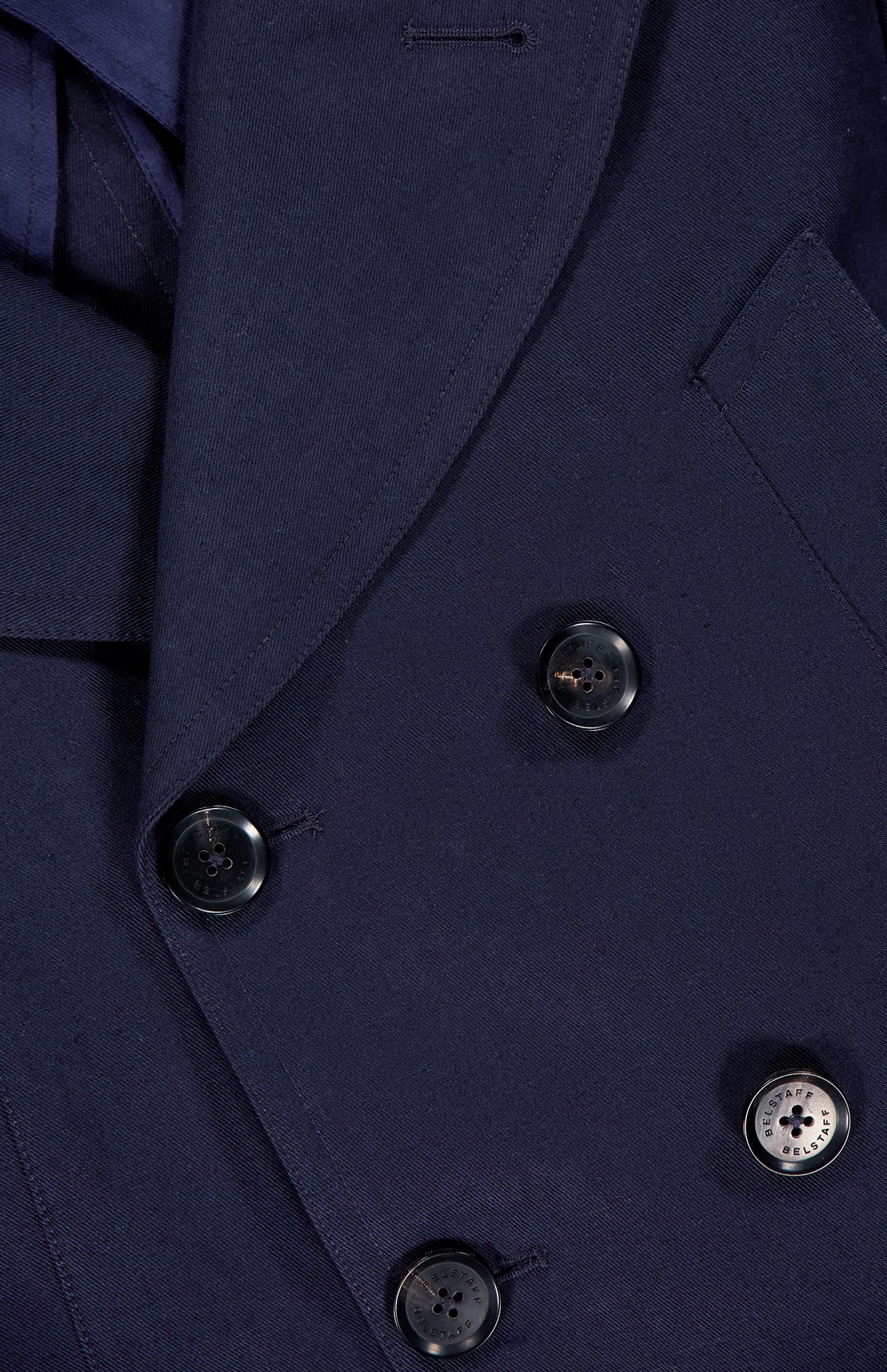 Close-up of the BELSTAFF Milford Water-resistant Peacoat in dark navy, featuring a double-breasted design with black buttons and a notched lapel.