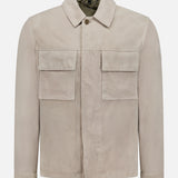 The BELSTAFF Waymark Suede Overshirt, shown on a plain white background, features a collared neckline, long sleeves, two large front flap pockets, and a hidden front zipper. Crafted from luxurious beige goat suede for lightweight layering.