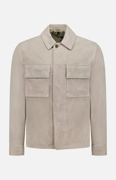 The BELSTAFF Waymark Suede Overshirt, shown on a plain white background, features a collared neckline, long sleeves, two large front flap pockets, and a hidden front zipper. Crafted from luxurious beige goat suede for lightweight layering.