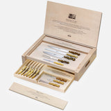 An open Milano Knives Box Set (Set of 15) by Berti Cutlery displays handmade knives with gold handles in a wooden presentation box, with printed logos on the lid and a tray for extra knives—a refined, luxury kitchen gift set.