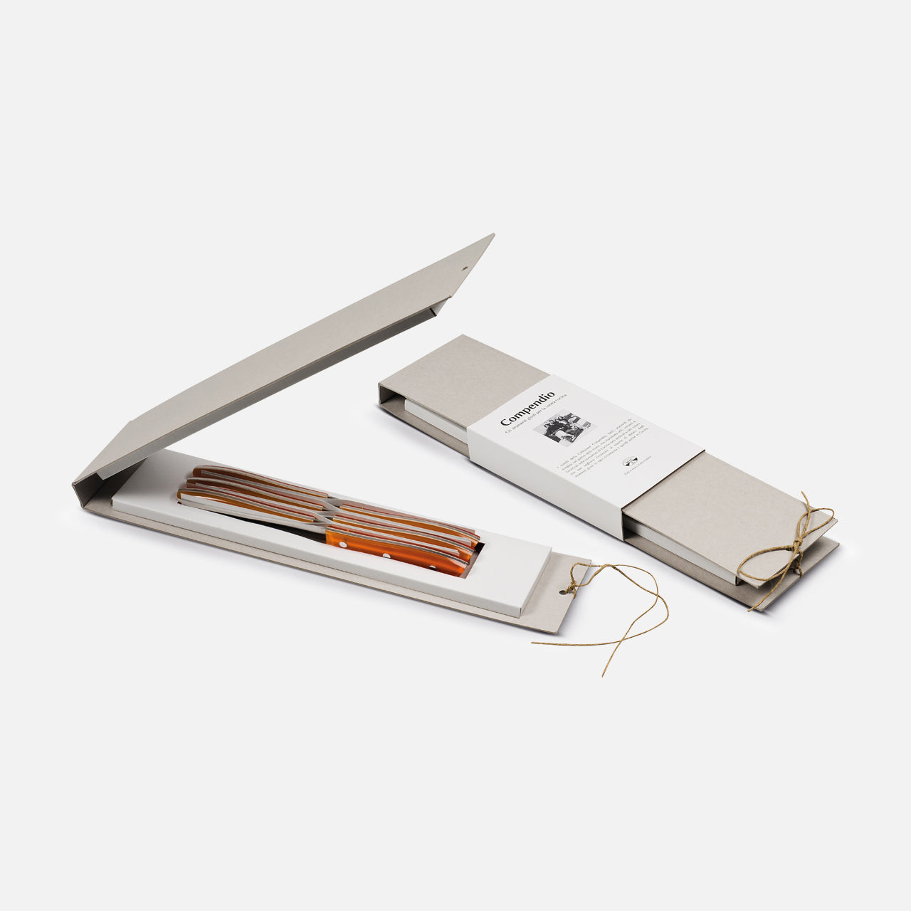 Two slim, beige Berti Cutlery boxes with string closures are shown. One is closed with a booklet on top; the other is open, displaying the Table Knife “Compendium” 6-piece set featuring elegant orange and brown striped handles.