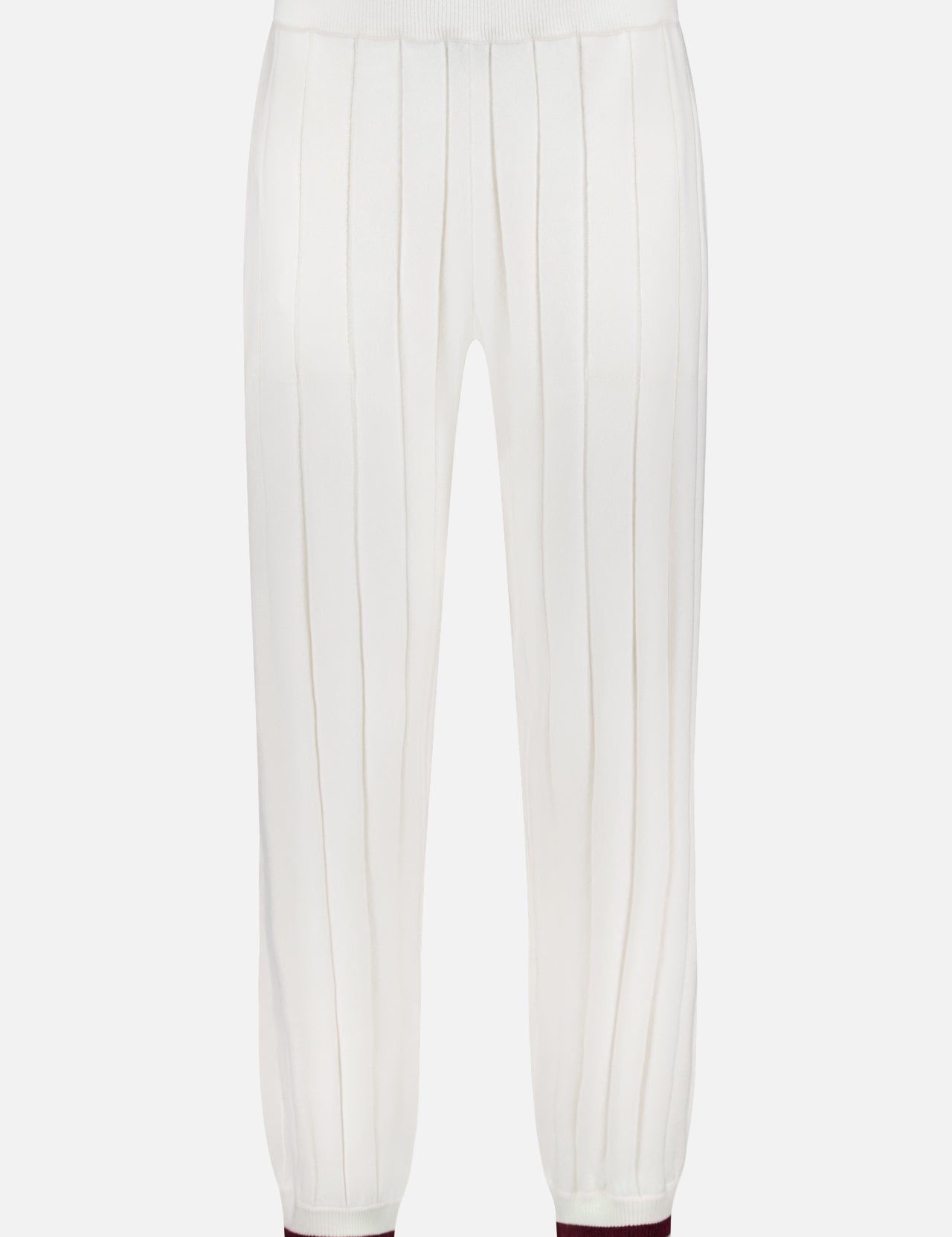 The BRUNELLO CUCINELLI Ribbed Cashmere Travel Pant features white knit fabric with vertical ribbing, an elastic waistband, cuffed ankles with a maroon stripe, and offers relaxed comfort for stylish casual outings.