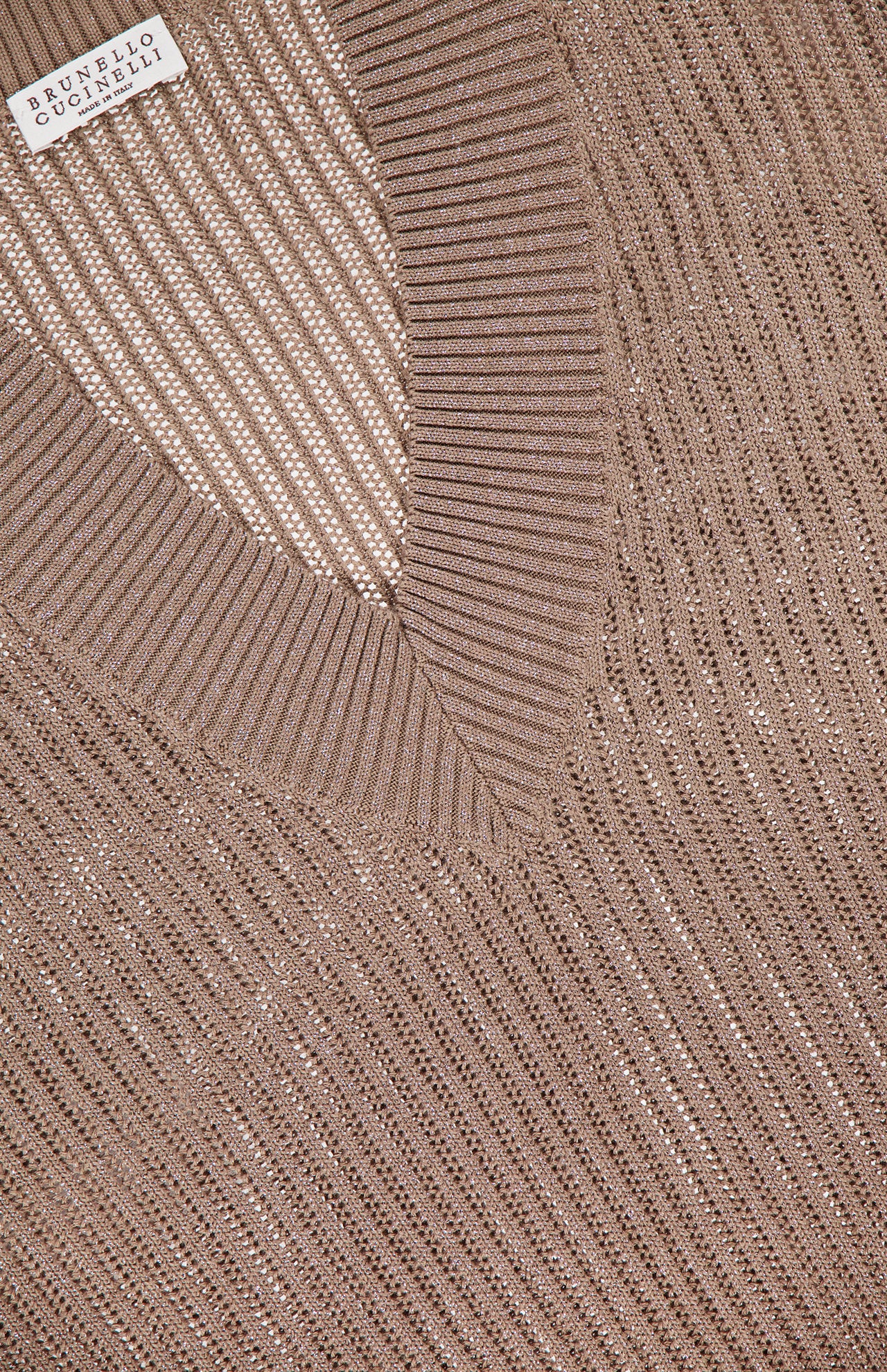 Close-up of a taupe BRUNELLO CUCINELLI Lurex Cotton Echo Long Sleeve Pullover Sweater featuring ribbed edges, subtle shimmer, and a visible fabric label in the upper left corner.