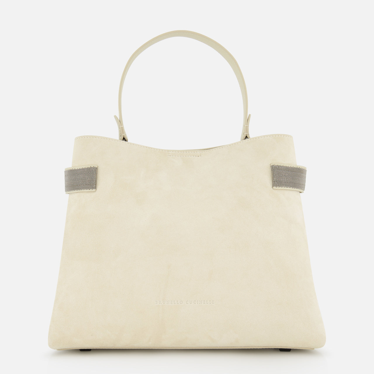 The BRUNELLO CUCINELLI Medium Soft Velour Essence Bag is a beige suede handbag with a structured shape, two short handles, and small gray strap accents, displayed against a white background.