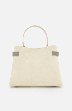 The BRUNELLO CUCINELLI Medium Soft Velour Essence Bag is a beige suede handbag with a structured shape, two short handles, and small gray strap accents, displayed against a white background.