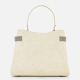 The Medium Soft Velour Essence Bag by BRUNELLO CUCINELLI showcases ivory suede with monili embroidery, a single rounded handle, and two gray side accents, displayed against a plain white background.