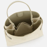 The BRUNELLO CUCINELLI Medium Soft Velour Essence Bag in beige features a structured design with two sturdy handles, an open top, and a well-organized interior with a central zippered pocket and multiple side compartments.