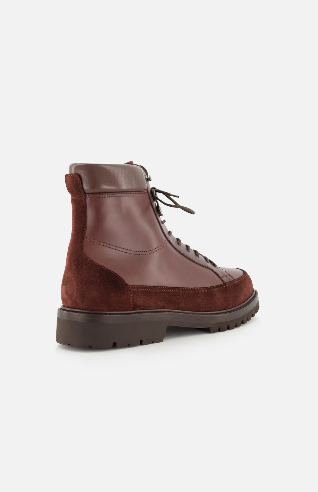 The Leather and Suede Ankle Boots by BRUNELLO CUCINELLI are Italian-crafted brown lace-up boots combining smooth leather and suede, set on a thick rubber sole. The image displays side and back views against a white background.