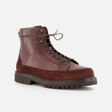 The Leather and Suede Ankle Boots by BRUNELLO CUCINELLI are expertly crafted in Italy, featuring a lace-up design in rich brown leather and suede with a rugged dark rubber sole, shown against a plain white background.