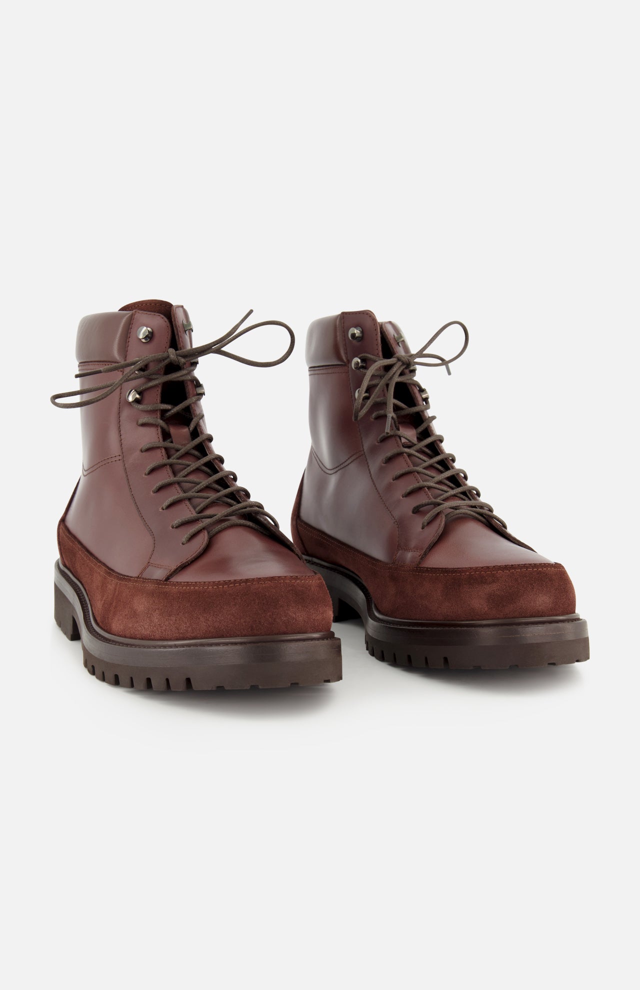 A pair of BRUNELLO CUCINELLI Leather and Suede Ankle Boots, featuring thick rubber soles and suede detailing, are positioned side by side on a white background. Expertly crafted in Italy, these boots combine style and durability for any adventure.