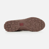 BRUNELLO CUCINELLI’s Ankle Hiker Boots feature a brown rubber sole with a rugged tread pattern composed of geometric shapes and textured grooves for dependable traction—perfect for outdoor adventures. A small red BRUNELLO CUCINELLI logo appears near the center, and the sole is shown against a white background.