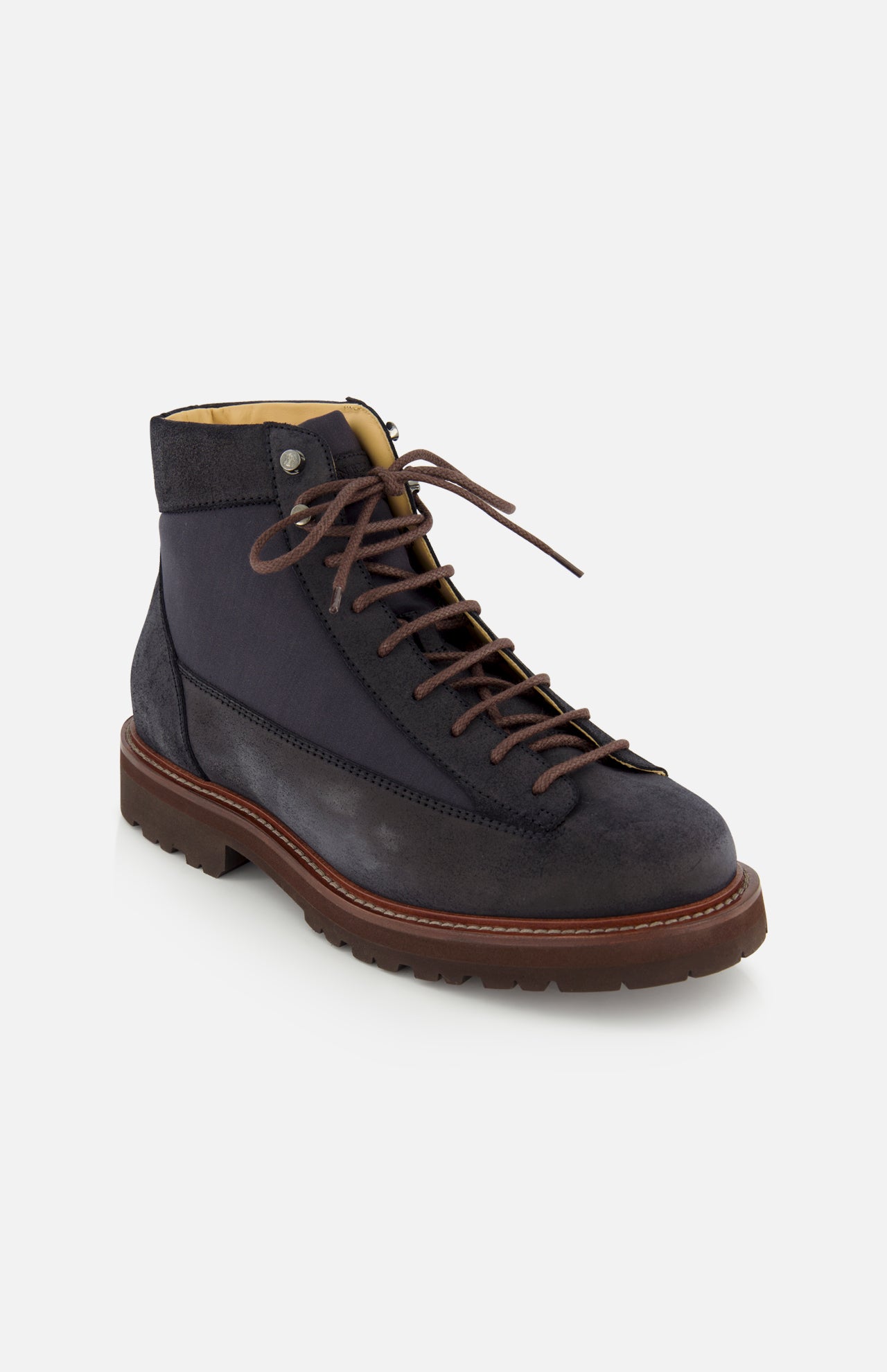 The BRUNELLO CUCINELLI Suede Ankle Boots are shown on a white background, angled to display both the side and front. This classic lace-up style features a dark navy suede upper, brown laces, a brown sole, and black accents.