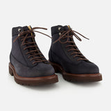 A pair of BRUNELLO CUCINELLI Suede Ankle Boots in navy, designed in a classic lace-up style with brown soles and matching brown laces, displayed on a white background.