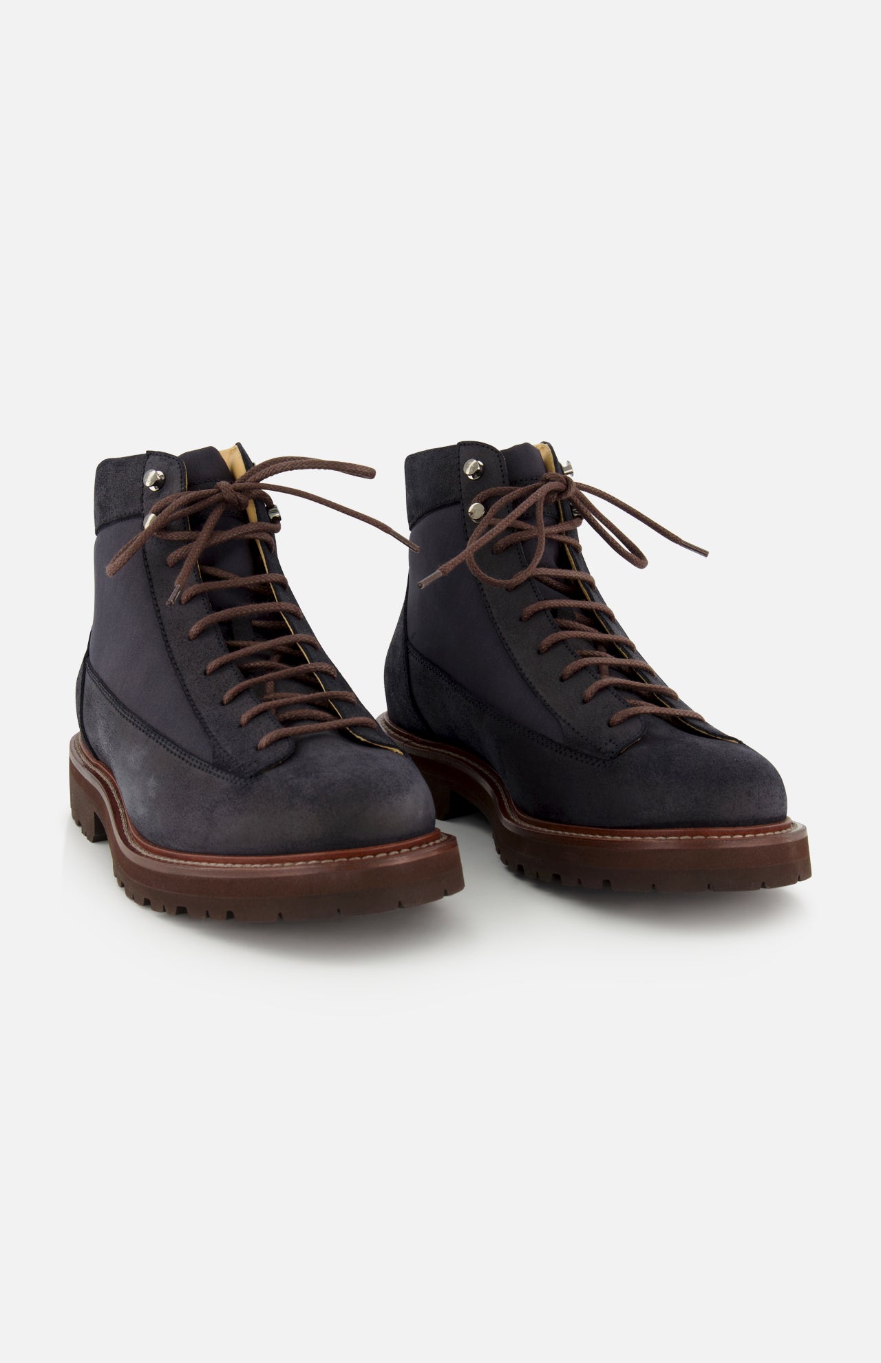 A pair of BRUNELLO CUCINELLI Suede Ankle Boots in navy, designed in a classic lace-up style with brown soles and matching brown laces, displayed on a white background.