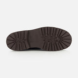 A brown rubber sole—designed with thick tread patterns and deep grooves for enhanced traction and durability—is pictured from the bottom against a white background, making it the ideal replacement for your BRUNELLO CUCINELLI Suede Ankle Boots.
