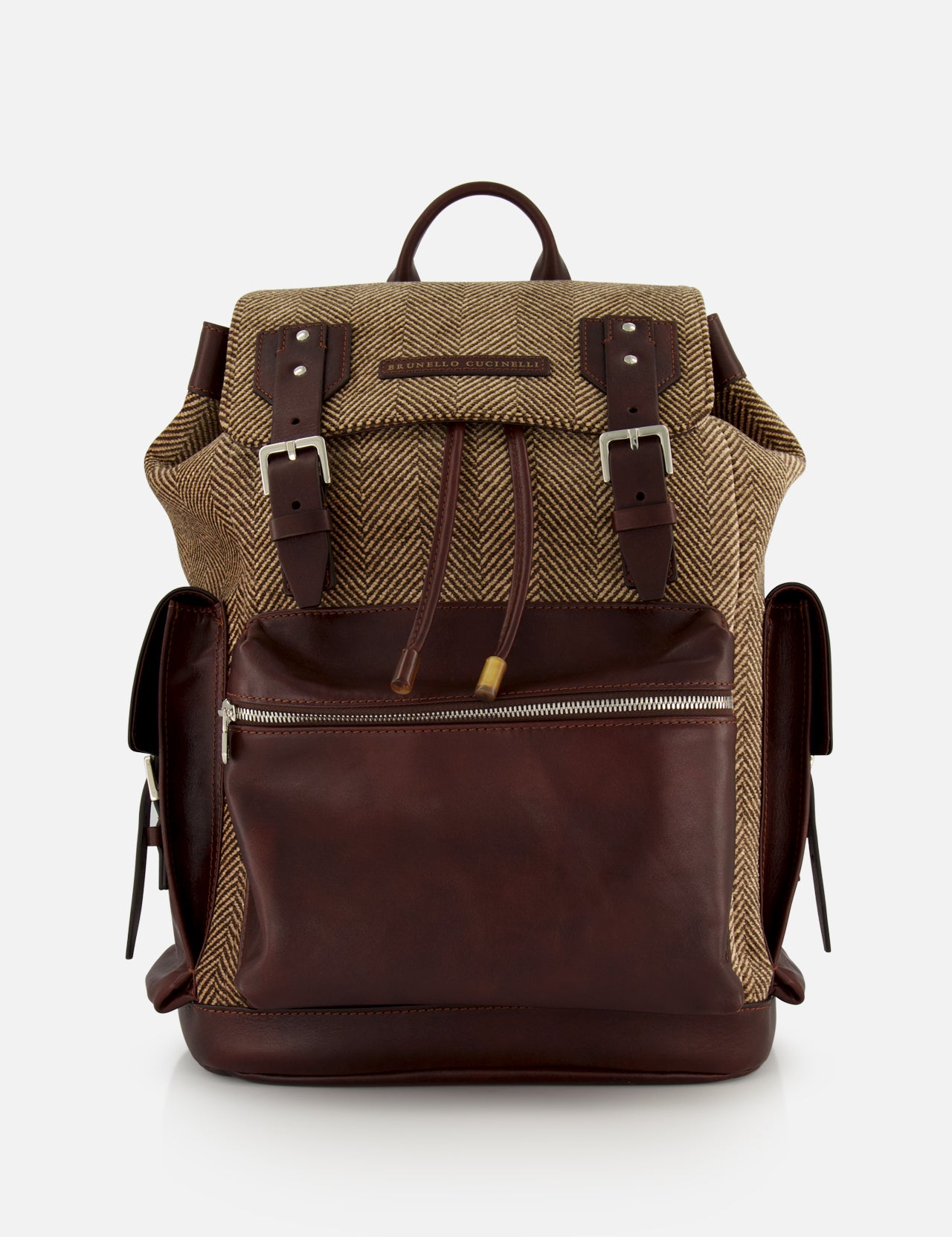 A BRUNELLO CUCINELLI Vintage Chevron-effect Backpack, featuring a brown leather and herringbone fabric design with front zipper pocket, buckle straps, leather inserts, adjustable shoulder straps, and side pockets, is displayed against a plain white background.