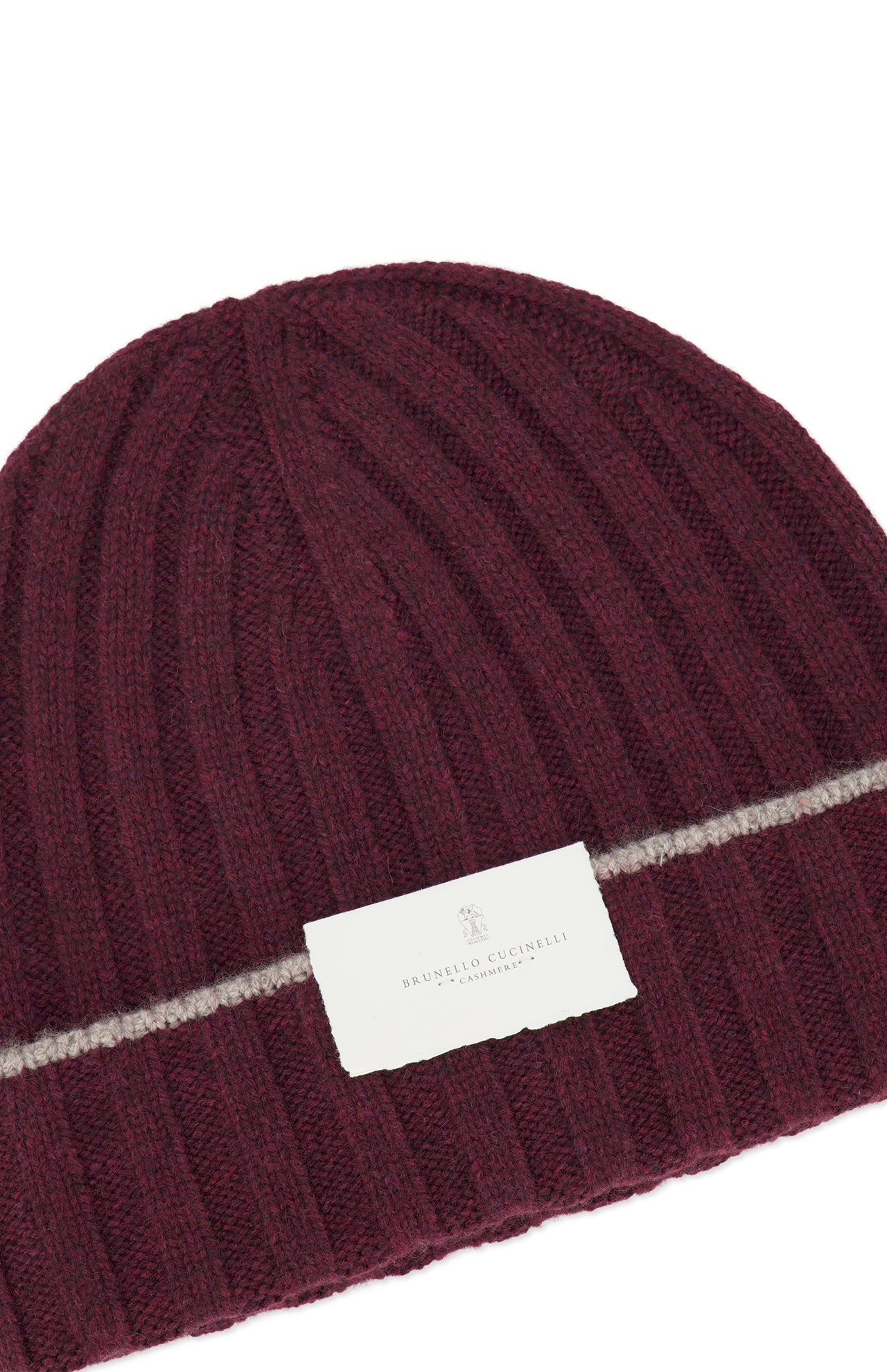 A rib-knit cashmere beanie in burgundy by BRUNELLO CUCINELLI, featuring a thin horizontal beige stripe and a white label with the brand name.