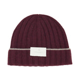 Introducing the Rib-knit Cashmere Beanie by BRUNELLO CUCINELLI: a stylish burgundy hat crafted in a classic rib-knit design for added texture and warmth, featuring a folded brim with a thin gray stripe above it and finished with a white rectangular label on the front.