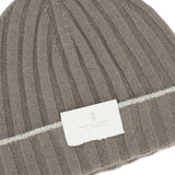 The Rib-knit Cashmere Beanie by BRUNELLO CUCINELLI features taupe rib-knit cashmere accented with a white stripe and a white front label displaying the brand name, offering both cozy warmth and refined style.