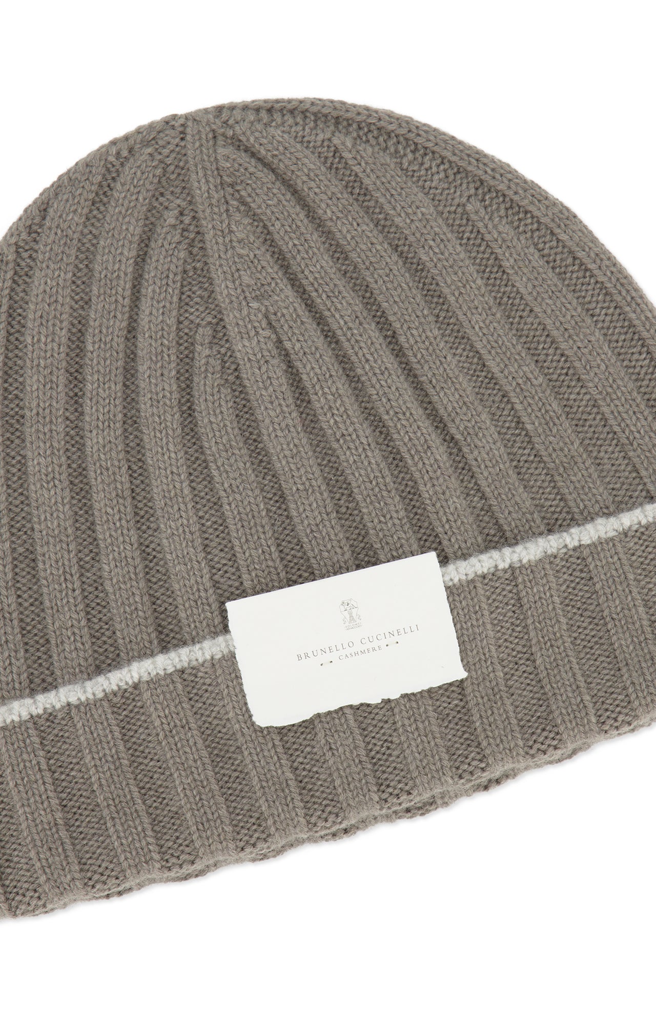 The Rib-knit Cashmere Beanie by BRUNELLO CUCINELLI features taupe rib-knit cashmere accented with a white stripe and a white front label displaying the brand name, offering both cozy warmth and refined style.