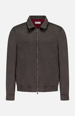 The BRUNELLO CUCINELLI Wool Bomber Jacket is showcased against a plain white background, featuring a dark brown hue with a zip-up front, classic collar, long sleeves, and an elasticized hem. Inspired by Brunello Cucinelli’s renowned craftsmanship, this virgin wool bomber is finished with a distinctive red label tag on the inside of the collar for an added touch of refinement.