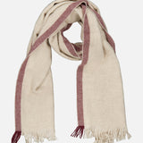 The BRUNELLO CUCINELLI Cashmere Contrast Stripe Scarf features a beige cashmere fabric accented by maroon stripes along the edges, finished with fringed ends and a soft, woven texture that ensures luxurious warmth. The scarf is showcased against a plain white background.