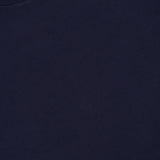 Close-up of the upper section of the BRUNELLO CUCINELLI Cotton Crewneck T-Shirt in dark navy blue, highlighting the collar and a partial label featuring “Brunello Cucinelli” and “Made in Italy” text against a white background. This slim-fit crewneck exemplifies refined craftsmanship and contemporary style.