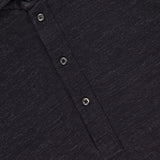 Close-up of the BRUNELLO CUCINELLI Cotton Linen Short Sleeve Polo Shirt in dark grey, featuring a three-button placket, visible collar, and textured heathered fabric. Part of the inside tag is shown at the top left.