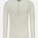 The BRUNELLO CUCINELLI Cotton Long Sleeve Henley T-shirt features a cream waffle knit, round collar, and three-button placket, shown against a plain white background.