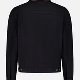 The Denim with Leather Collar Jacket by BRUNELLO CUCINELLI features a black denim back view, dark leather collar, long sleeves, buttoned cuffs and waistband tabs, plus classic visible stitching for a timeless retro style.