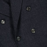 Close-up of the BRUNELLO CUCINELLI Double Breasted Suit Jacket in dark grey virgin wool, featuring six black buttons and a hint of red fabric at the top left corner.