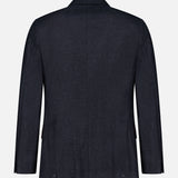 The Double Breasted Suit Jacket by BRUNELLO CUCINELLI is featured from the back against a plain light background. This dark navy blazer is crafted from virgin wool, showcasing a classic design with a notched collar and long sleeves, without any visible embellishments or patterns.
