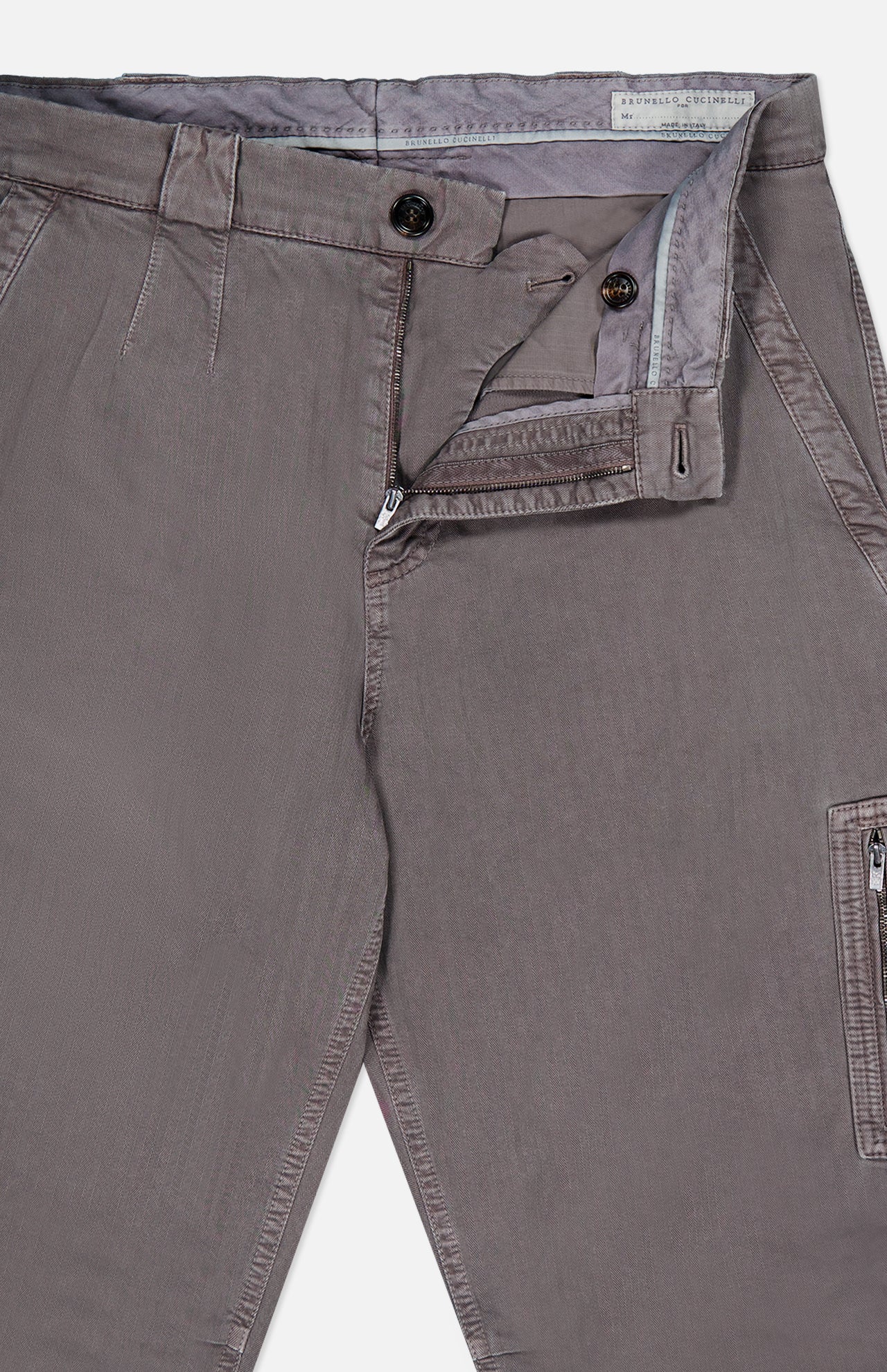 Close-up of BRUNELLO CUCINELLI Dyed Zigzag Cargo Trousers in light brown cotton, with the fly open to reveal a zipper, two buttons, and part of the waistband and pocket lining.