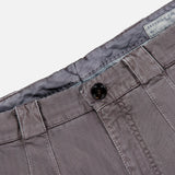 Close-up of the waistband and button of the BRUNELLO CUCINELLI Dyed Zigzag Cargo Trousers, featuring grey cotton chevron fabric with belt loops, visible stitching, and a partially revealed inner fabric label.