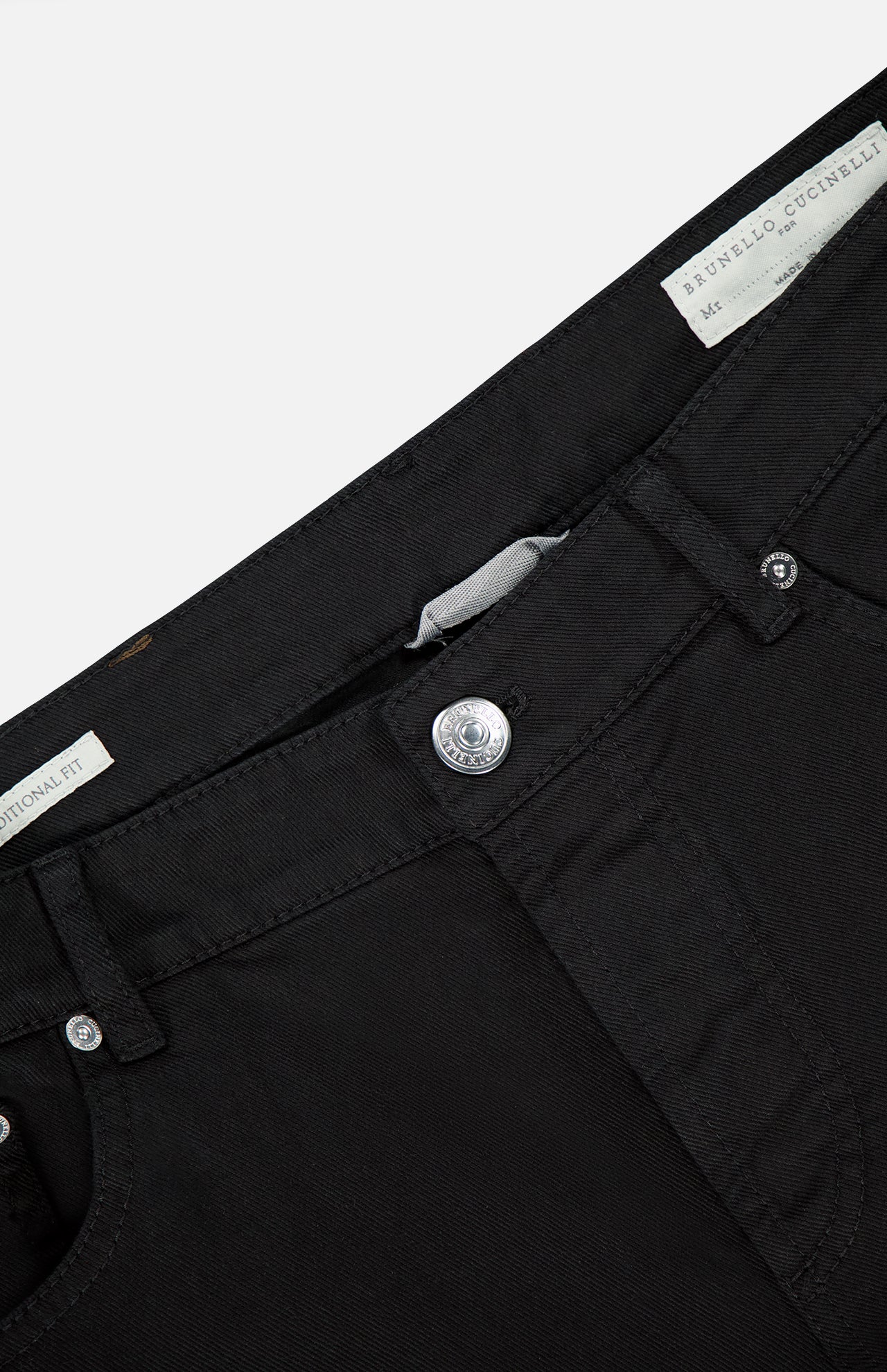 Close-up view of the waistband and upper front of BRUNELLO CUCINELLI Dyed Denim Jeans in Nero, highlighting the button, belt loops, and inner label with visible branding. Crafted from stretch denim. Made in Italy.