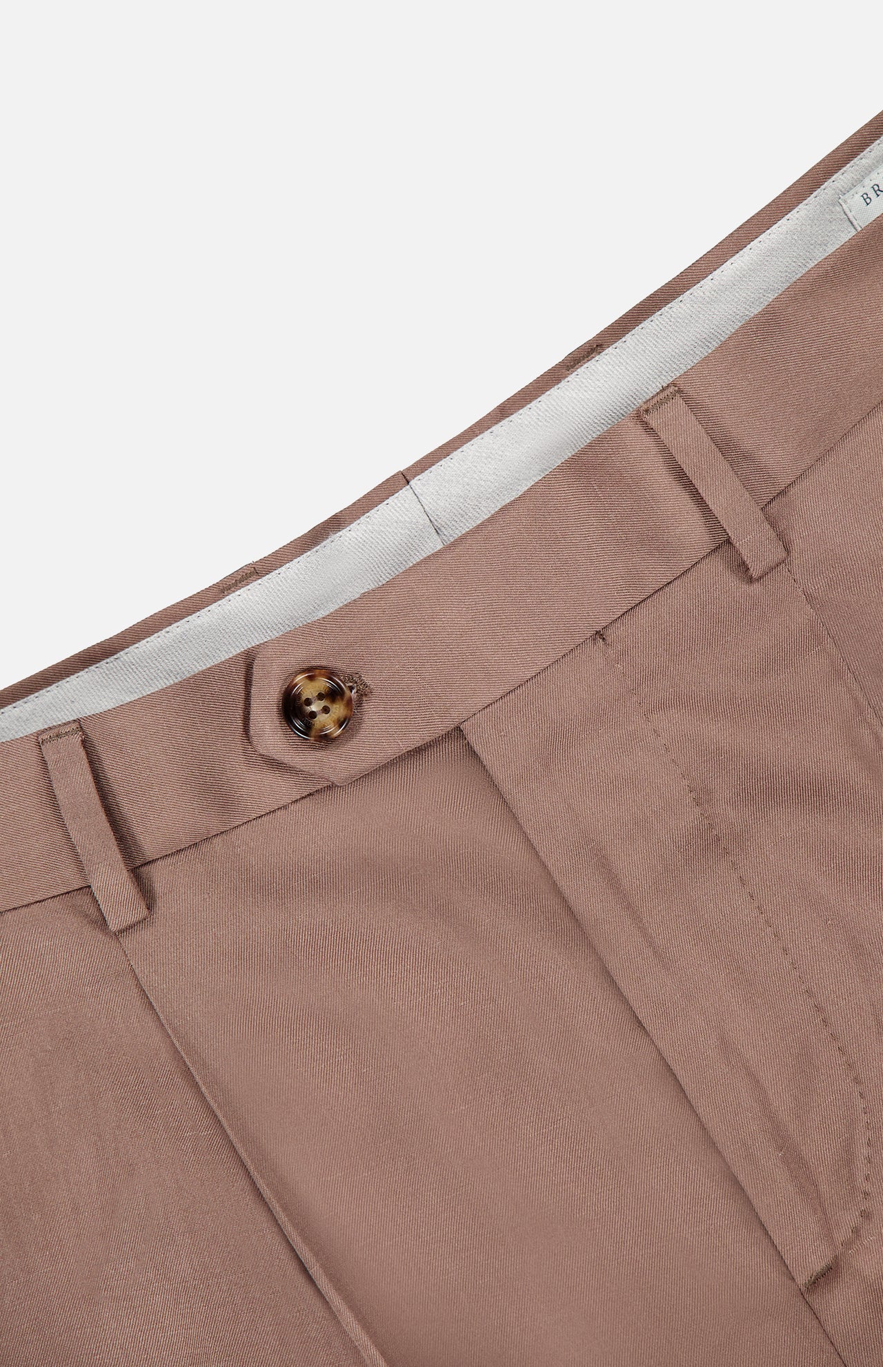 Close-up of the waistband and front of the BRUNELLO CUCINELLI Garbardina Delave Trouser Pant in light brown silk linen-blend, made in Italy, with a brown button closure, belt loops, and partially visible white inner lining.