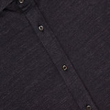 Close-up of a dark gray BRUNELLO CUCINELLI Jersey Long Sleeve Dress Shirt with a subtle textured pattern. Features three buttons and part of the collar. Made in Italy from a linen-cotton blend; the label displays the brand name.