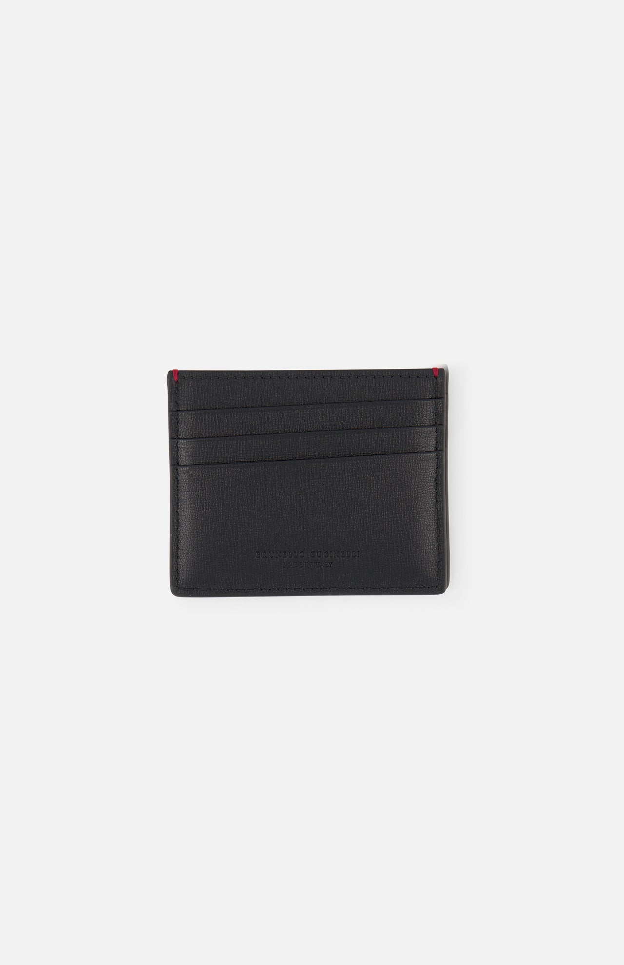 The BRUNELLO CUCINELLI Leather Cardholder with Middle Slot features minimalist black leather, three card slots per side, and subtle red stitching accents on the top corners, shown on a plain white background.