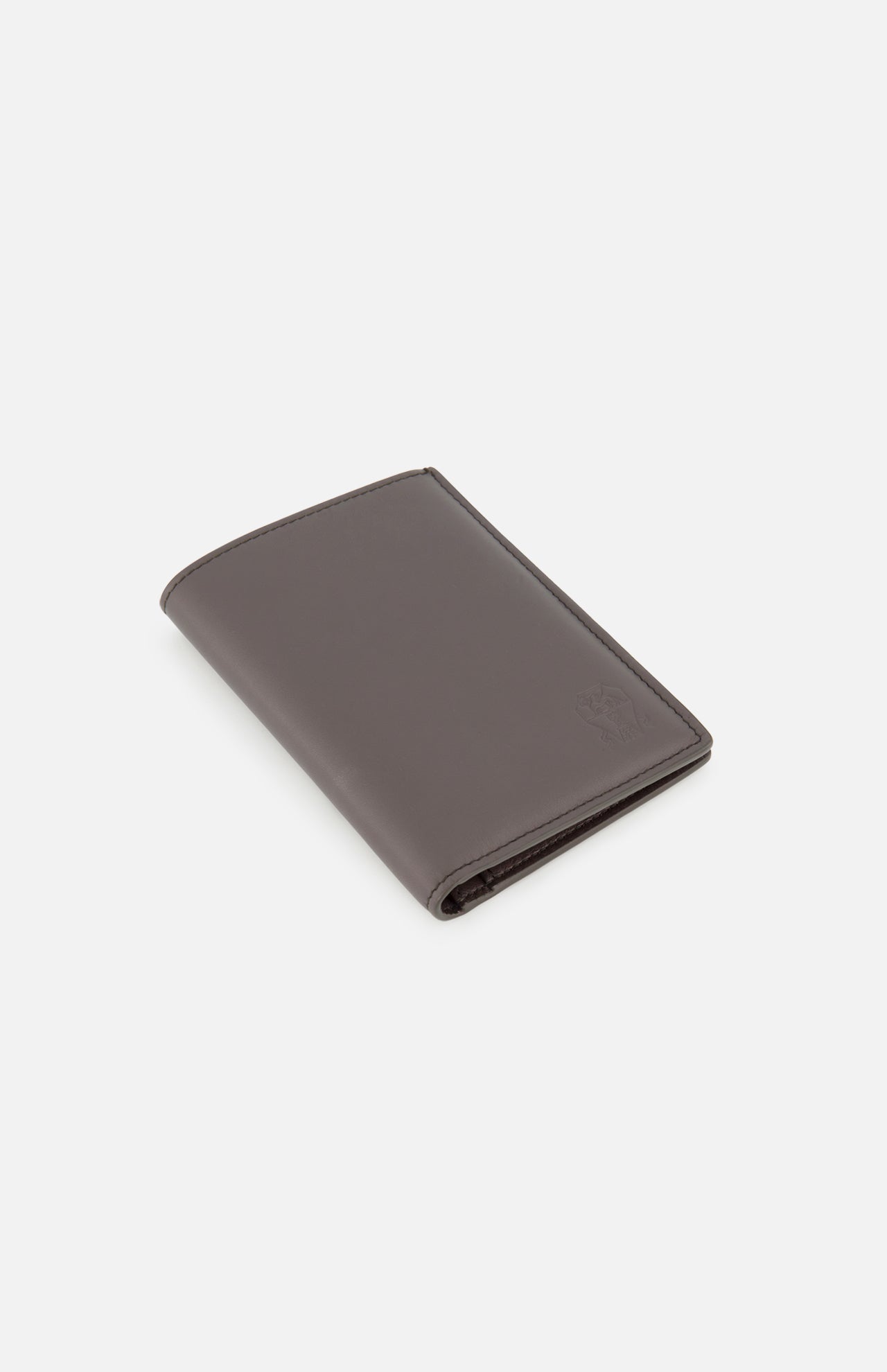 A closed Leather Passport and Cardholder by BRUNELLO CUCINELLI, crafted from brown leather with a subtle embossed logo in the corner, displayed on a plain white background.