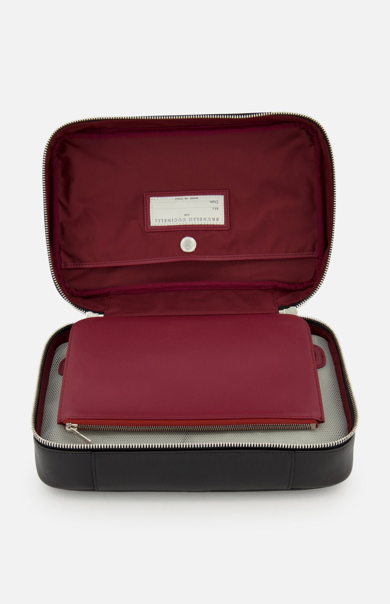 The BRUNELLO CUCINELLI Leather Dopp Kit in black leather opens to reveal a burgundy interior, a matching flat pouch, and an inside lid label. Sleek silver zippers add style to this neatly organized travel toiletry bag.