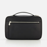 The BRUNELLO CUCINELLI Leather Dopp Kit, made in Italy, features black leather, a top handle, and a front zippered pocket. It is shown against a plain white background.