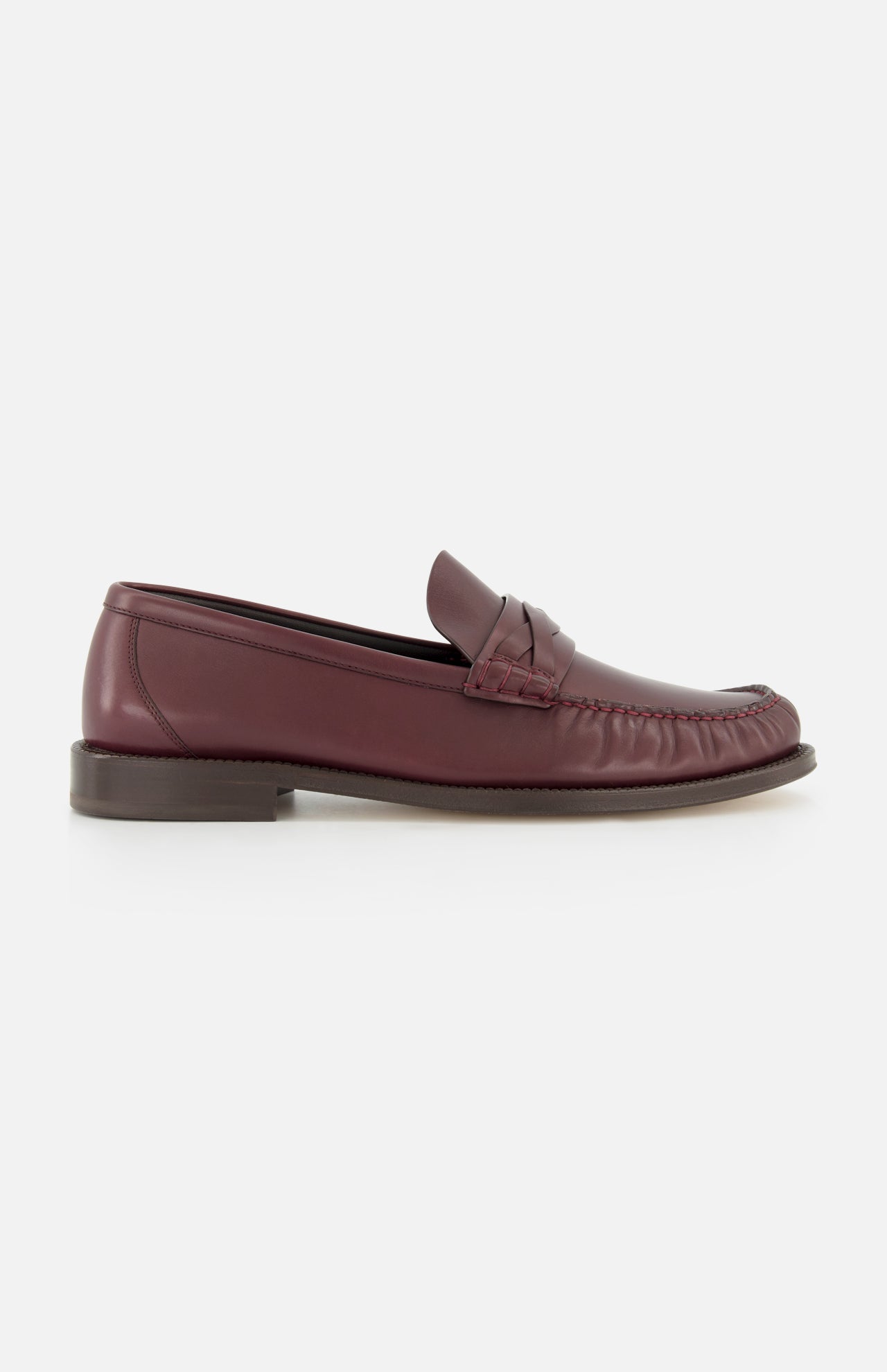 A menswear staple, the BRUNELLO CUCINELLI Leather Woven Band Loafers in burgundy feature a moccasin toe and low brown sole, displayed in side profile against a white background.