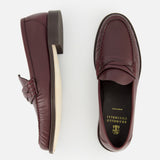 A pair of BRUNELLO CUCINELLI Leather Woven Band Loafers in classic burgundy leather, shown from the side and top, feature a black insole with "BRUNELLO CUCINELLI Made in Italy" in gold lettering.